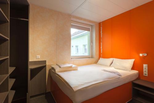 a small bed in a room with a window at easyHotel Budapest Oktogon in Budapest
