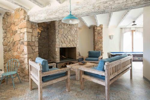 a living room with couches and a stone fireplace at Mas del Sord 1335 in La Selva del Camp