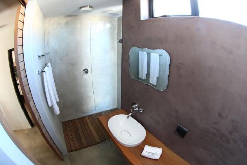 a bathroom with a sink and a shower and a toilet at Windtown Lagoon Hotel in Langebaan