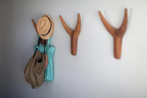 a hat and antlers hanging on a wall at Windtown Lagoon Hotel in Langebaan
