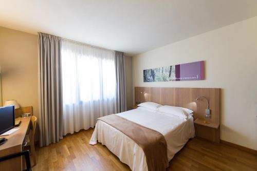 a hotel room with a bed and a window at Ca' Del Lupo in Montelupo Albese