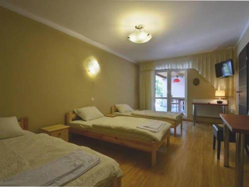 מיטה או מיטות בחדר ב-Bizancjum Pokoje Gościnne PARKING FREE 24H