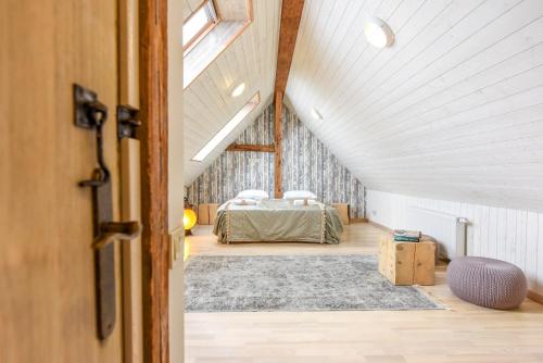 a bedroom with a bed in a attic at KUBU 4-rooms apartment in Klaipėda