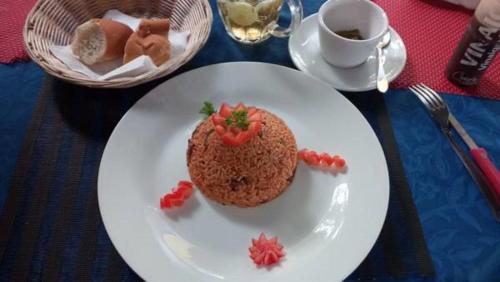 a white plate with a cake with a heart on it at Hotel Napoleon Lagune in Lomé
