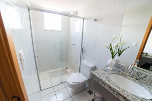 a bathroom with a toilet and a sink and a shower at Serra Madre Hotel in Rio Quente