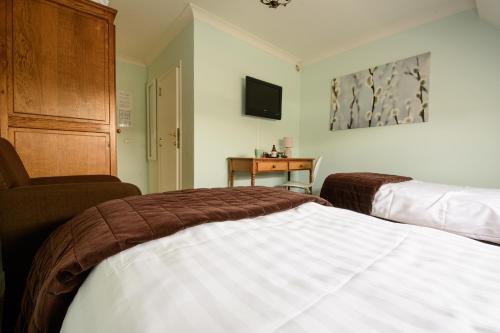 Un pat sau paturi într-o cameră la 'T Buskruid Hotel
