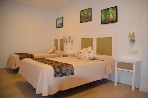 A bed or beds in a room at Hotel Doña Lina