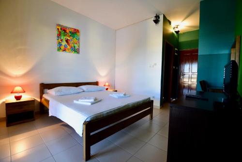 a bedroom with a bed and a painting on the wall at Pansion HRGA in Vodice