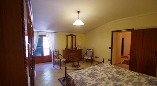 a bedroom with a bed and a table and chairs at Casa Sotto La Rocca in Radicofani