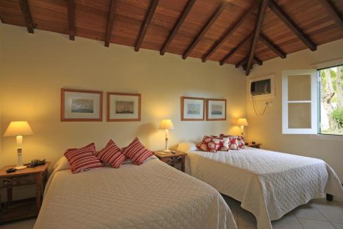 Tempat tidur dalam kamar di Residence dos Búzios