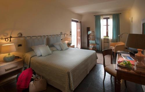 a bedroom with a bed and a desk with a computer at Villa Tiboldi in Canale