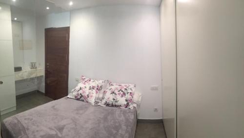 a bedroom with a bed with a pillow on it at Dream Canteras in Las Palmas de Gran Canaria