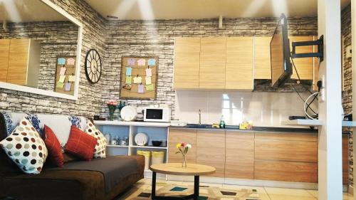 a living room with a couch and a kitchen at Non Smoking Theda Evo Soho Bangi with Coway & Wifi - Pool Tutup in Bangi