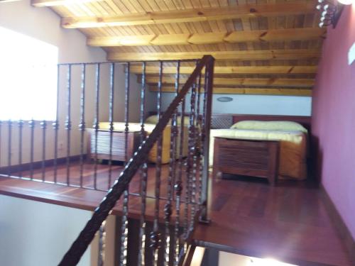 a spiral staircase in a room with a bed at Casa Lola in Villastose