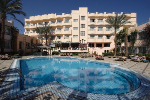 a swimming pool in front of a hotel at Sea Garden Hotel in Hurghada