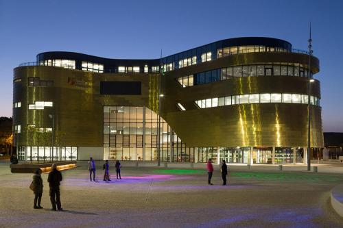people standing outside of a large building at night at OutRam 26 in Stockton-on-Tees