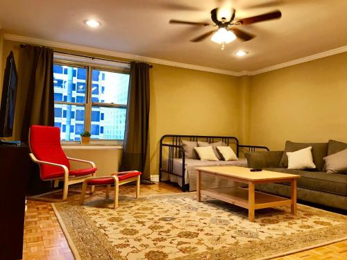 a living room with a couch and a table at Laugh, Eat, Sleep Downtown Wine Down 9E in Atlanta