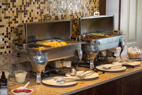 a kitchen with two trays of food on a counter at Ivy Court Inn and Suites in South Bend