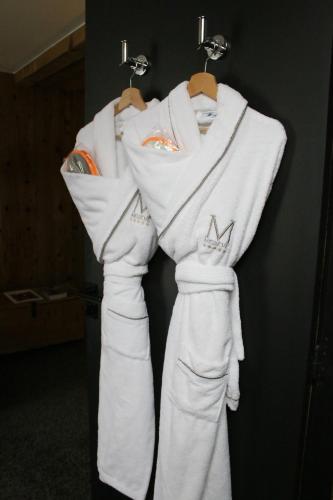 a group of white towels hanging on a rack at M de Megève in Megève