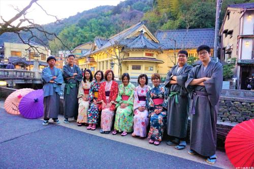a group of people posing for a picture with umbrellas at Morizuya in Toyooka