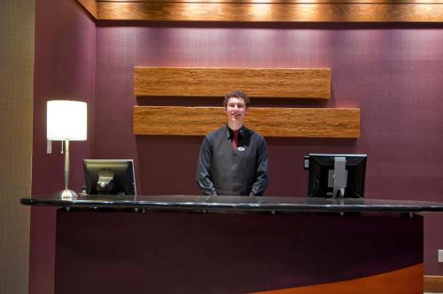 a man standing behind a desk in a room at Legends in Whistler