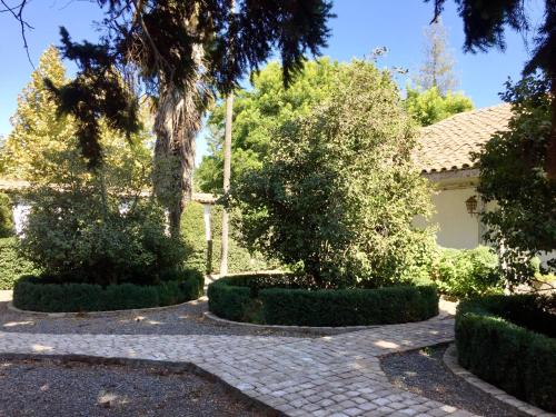 a house with trees and a brick driveway at Hotel Casa Silva in San Fernando