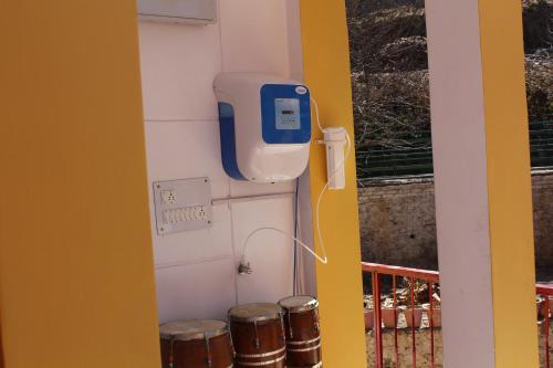 a wall with a soap dispenser and three drums at THE GROOVE GARDEN DHANOLTi in Dhanaulti