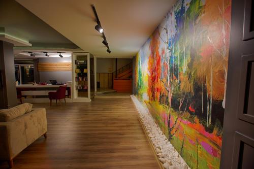 a hallway with a colorful painting on the wall at HMA Hotel & Suites in Alanya