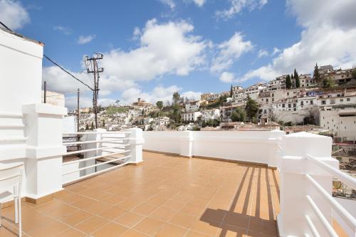 a white balcony with a view of a city at Atenas Granada in Granada