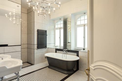 a bathroom with a bath tub and a sink at Villa Camoufle in Metz