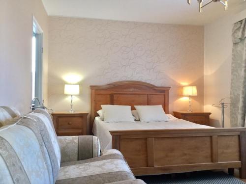 a bedroom with a bed and a couch and two lamps at Ullanlinna Studio in Helsinki