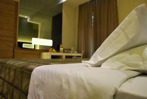 a hotel room with a bed and a television at Idea Hotel Plus Savona in Savona