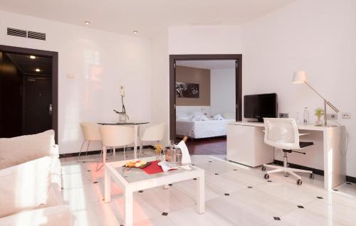a living room with a couch and a table at URH Ciutat de Mataró in Mataró