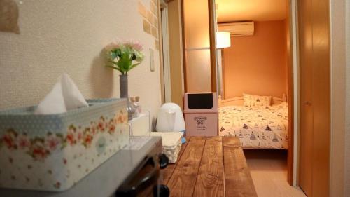 a room with a bedroom with a bed and a table at Mori de house in kobe 4 in Kobe