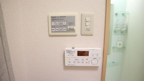 a control panel on a wall in a room at Mori de house in kobe 4 in Kobe