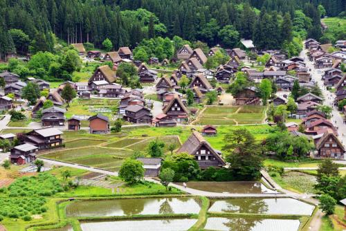 an aerial view of a small village with houses at Shirakawago Guest House Kei in Shirakawa