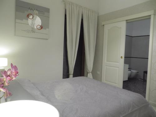 a bedroom with a bed and a door to a bathroom at B&B Mini Hotel Incity-close train station and port- in Salerno