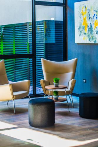 two chairs and a coffee table in a room at Five Hotel & Residences in Asuncion