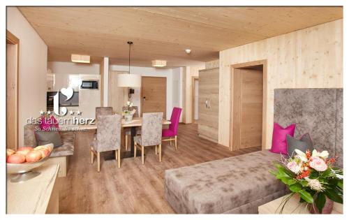 sala de estar con mesa y sillas moradas en Das Tauernherz, en Obertauern
