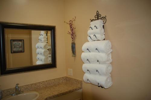 a stack of towels in a bathroom with a mirror at Greenhouse Inn by the Bay in Sequim
