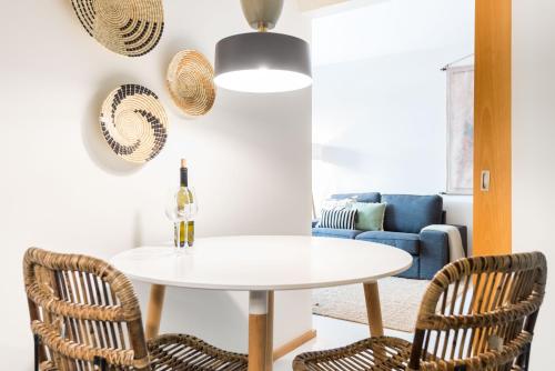 a dining room with a white table and two chairs at By the Sea Apartment with Large Private Terrace in Matosinhos