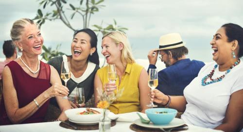 a group of women sitting at a table with wine glasses at Mistral Hotel - For Solo Travelers in Maleme
