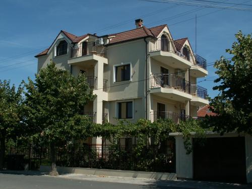 a white building with a red roof at Family Hotel Bellehouse in Chernomorets