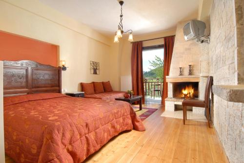 a bedroom with a bed and a fireplace at Mikri Arktos in Elati Trikalon