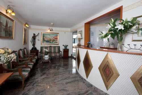a living room with chairs and a bar in a house at ApartHotel Vila Minka in Ljubljana