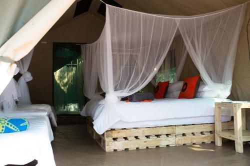 a bedroom with two beds in a tent at Southern Sands Eco Lodge in Hoedspruit