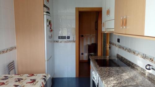 a kitchen with a sink and a counter top at Norte Sueve in Colunga