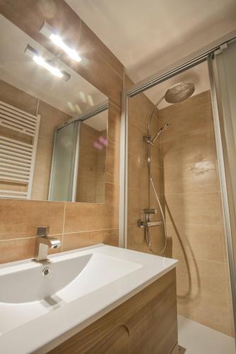 a bathroom with a white sink and a shower at Casa Rural Hortal in Barruera