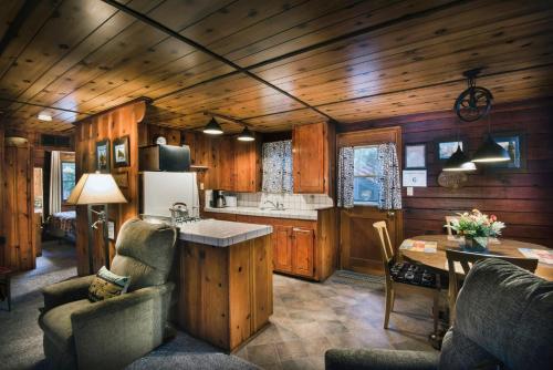 a kitchen and dining room of a log cabin at 16 Chipmunks Holiday in Wawona