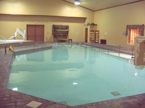 a large swimming pool with blue water in a building at Clifty Inn in Madison